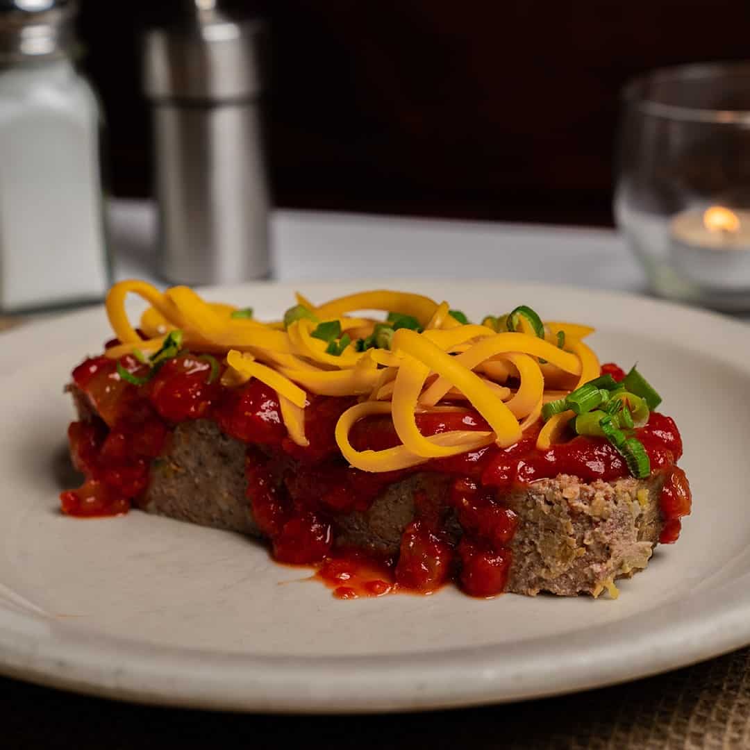 Homestyle meatloaf topped with tomato sauce and cheddar at Celebration Restaurant in Dallas