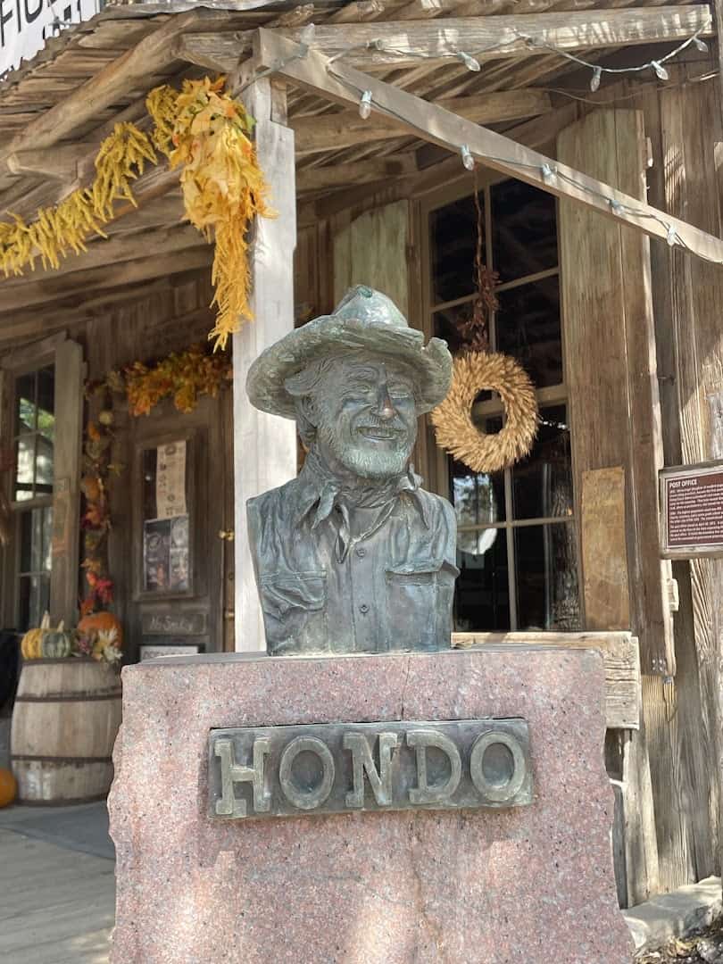 Bronze bust of Hondo Crouch outside the Luckenbach general store
