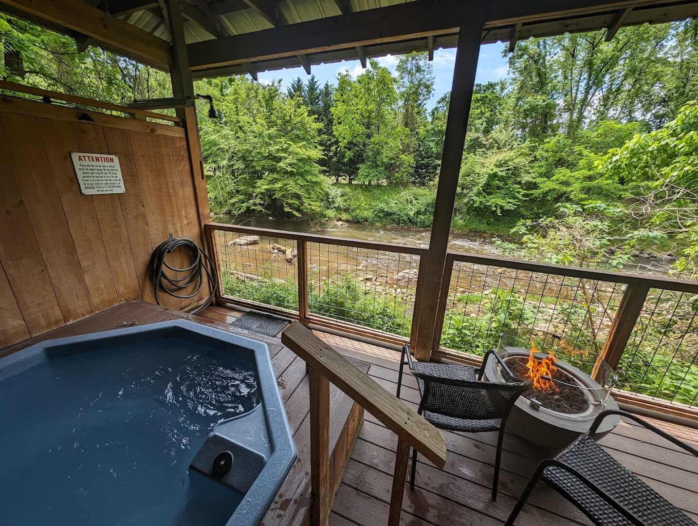 A private mineral tub on a deck overlooking the French Broad River at Hot Springs Resort and Spa in North Carolina