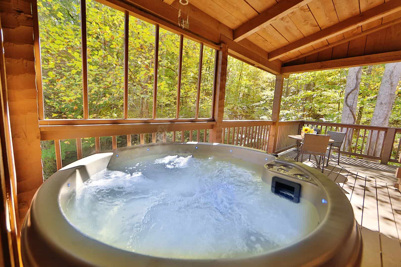 Steaming hot tub on a log cabin porch at Little Valley Mountain Resort, Sevierville, Tennessee