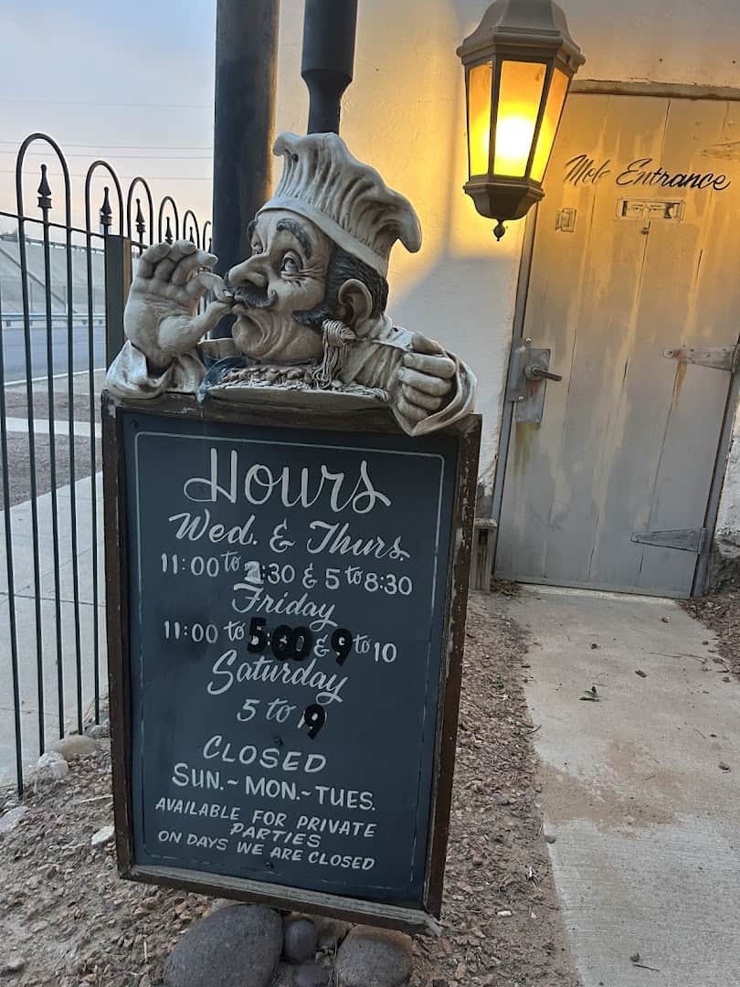 Hours sign and chef statue outside Monteleone's Italian Ristorante in El Paso