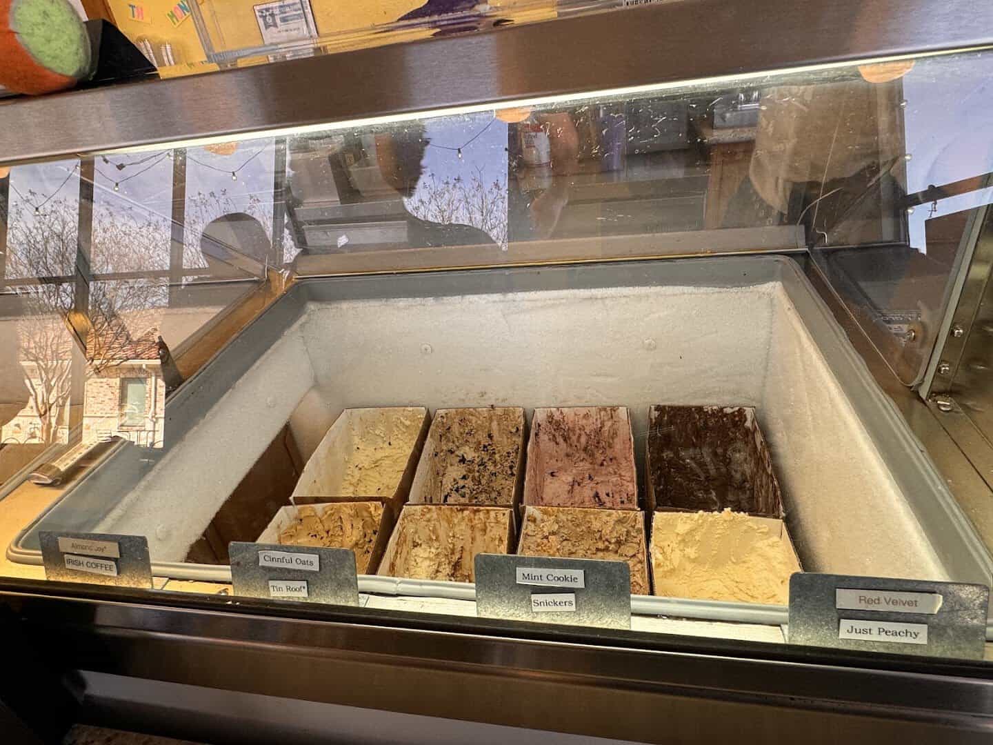 Tubs of house made ice cream flavors in the dipping case at Beth Marie's in Denton
