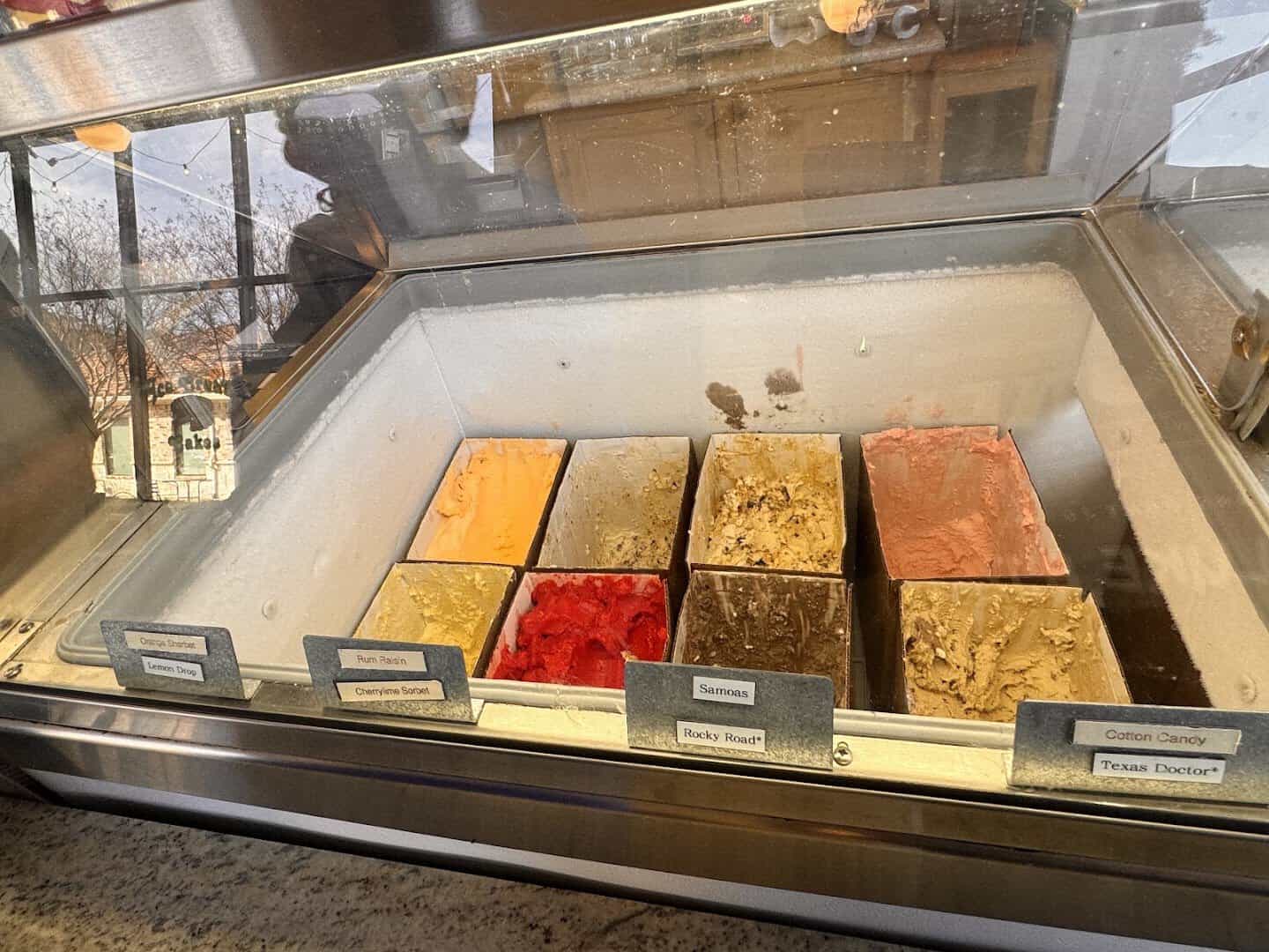 House made ice cream tubs lined up in the freezer case at Beth Marie's in Denton