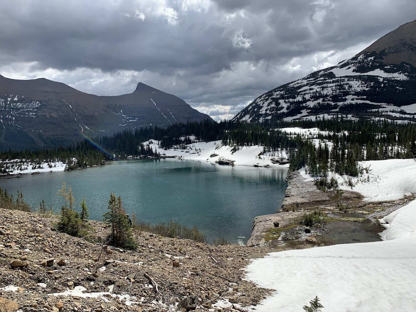 Turquoise ice-rimmed Iceberg Lake, Glacier National Park, Montana