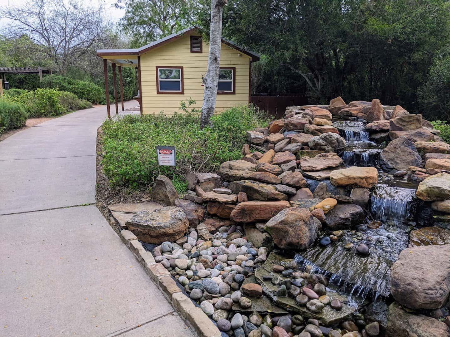Interpretive center building and waterfall at Edinburg Scenic Wetlands in Edinburg, Texas