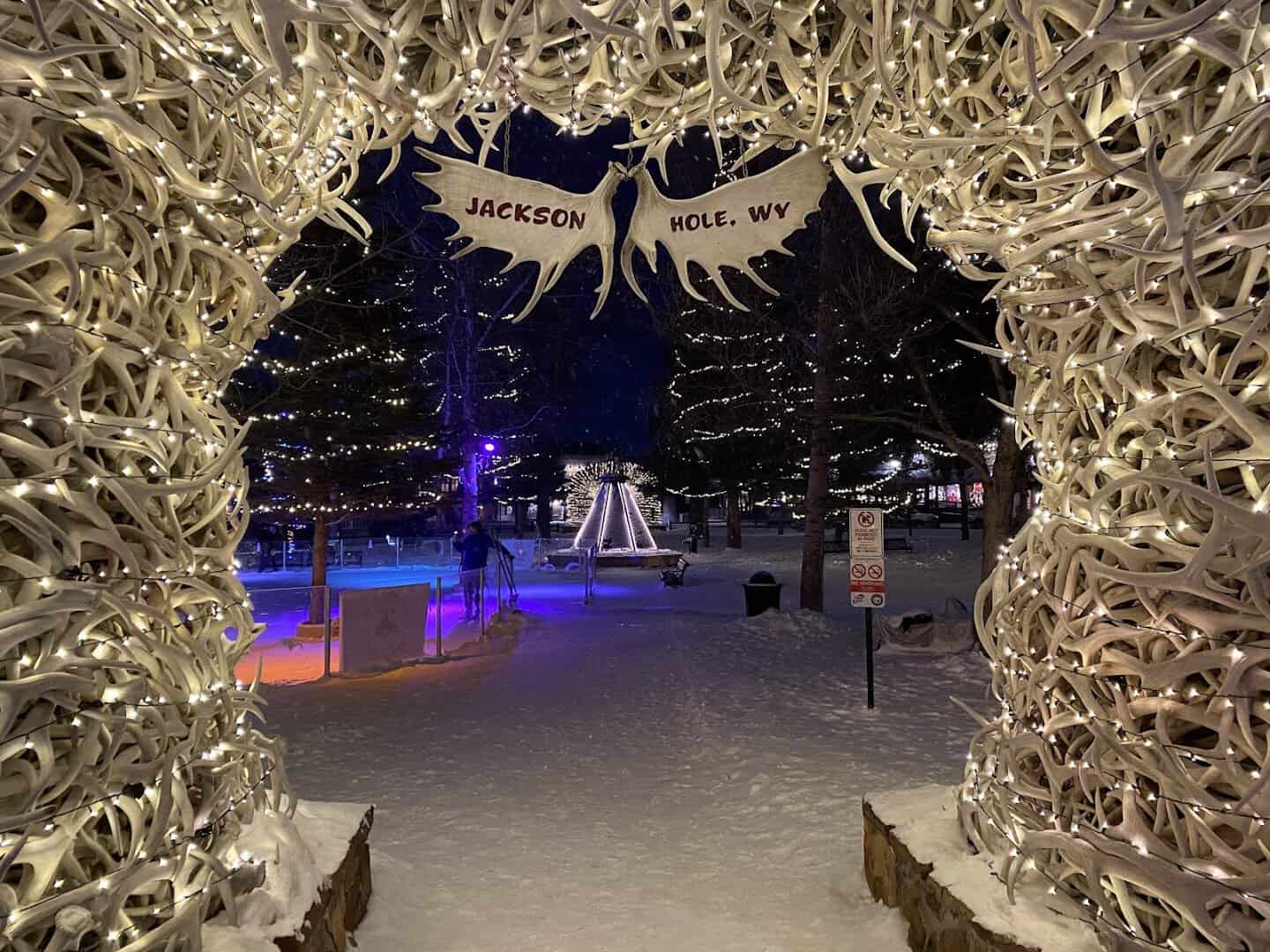 Elk antler arch lit at night over snow at the Jackson town square, Jackson, Wyoming