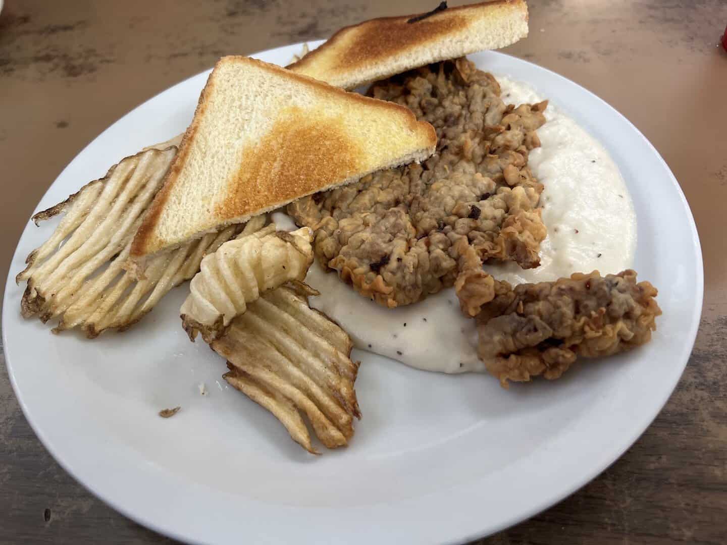 Chicken fried steak with cream gravy and waffle fries at Jake and Dorothy's Cafe in Stephenville, Texas