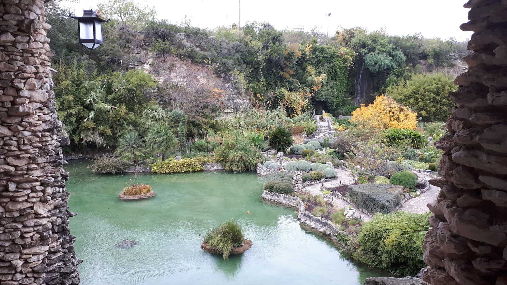 Stone lantern beside the pond and waterfall at the Japanese Tea Garden in San Antonio