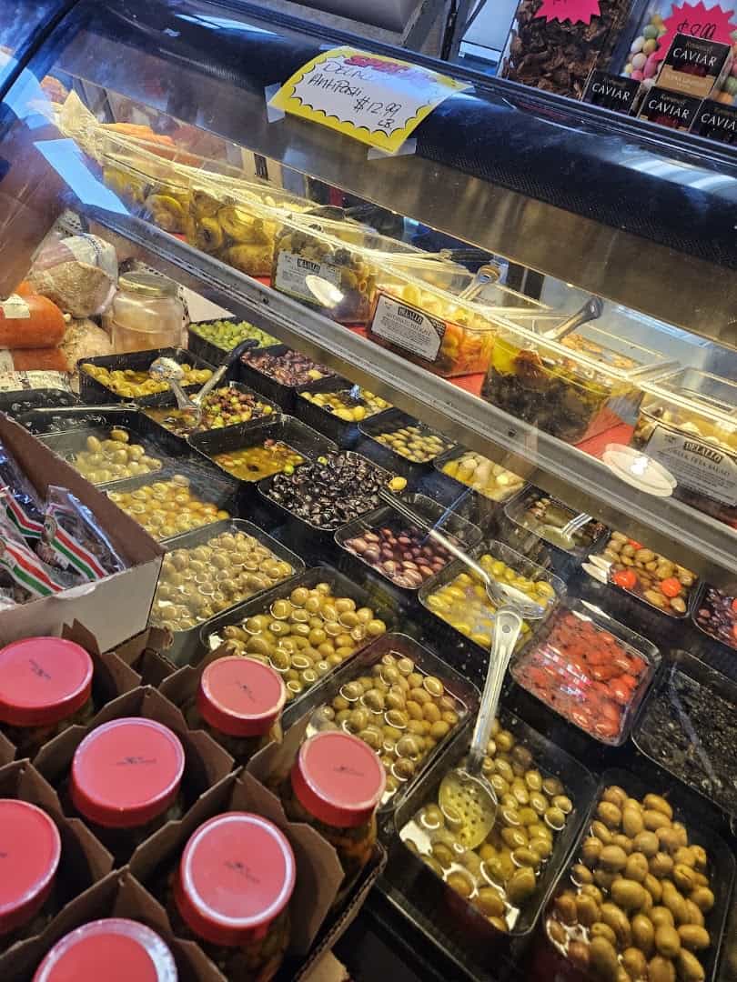 Trays of marinated olives and antipasti in the deli case at Jimmy's Food Store in Dallas