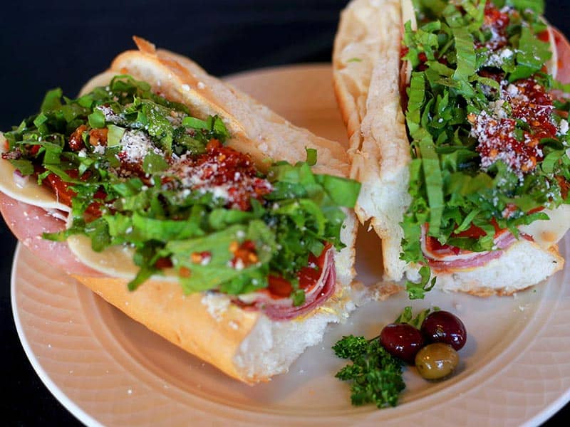 Loaded Italian sub with salami, arugula and shaved parmesan at Jimmy's Food Store in Dallas