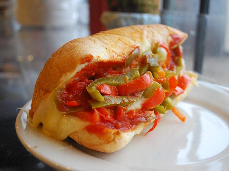 Sandwich piled with roasted peppers and melted provolone at Jimmy's Food Store in Dallas
