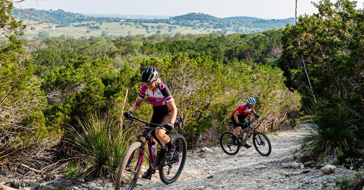 Cyclists riding a scenic Hill Country road near Kerrville, Texas