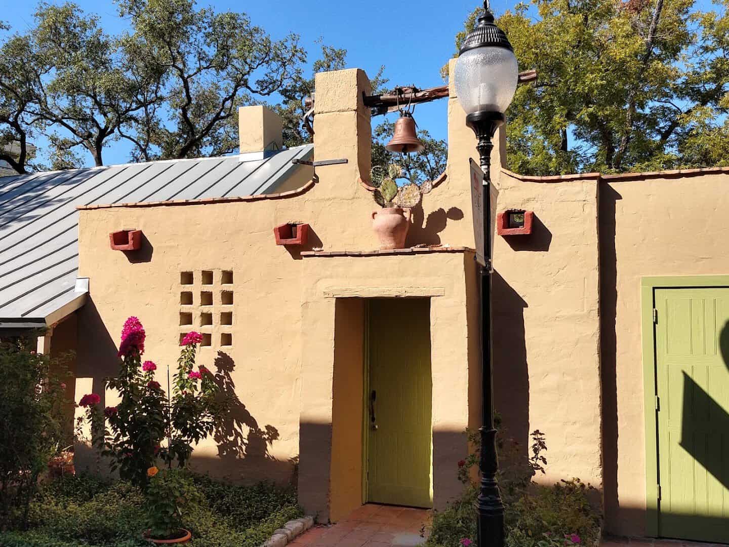 Historic adobe building with a metal roof at La Villita in San Antonio
