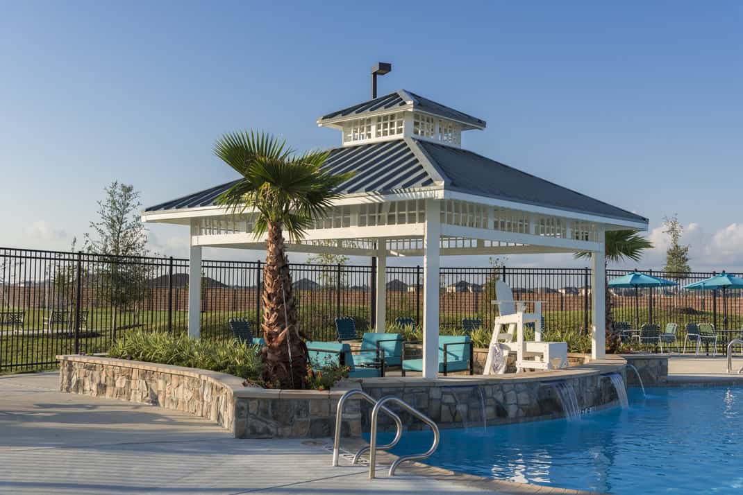 Poolside cabana pavilion with a waterfall feature at Lago Mar in Texas City
