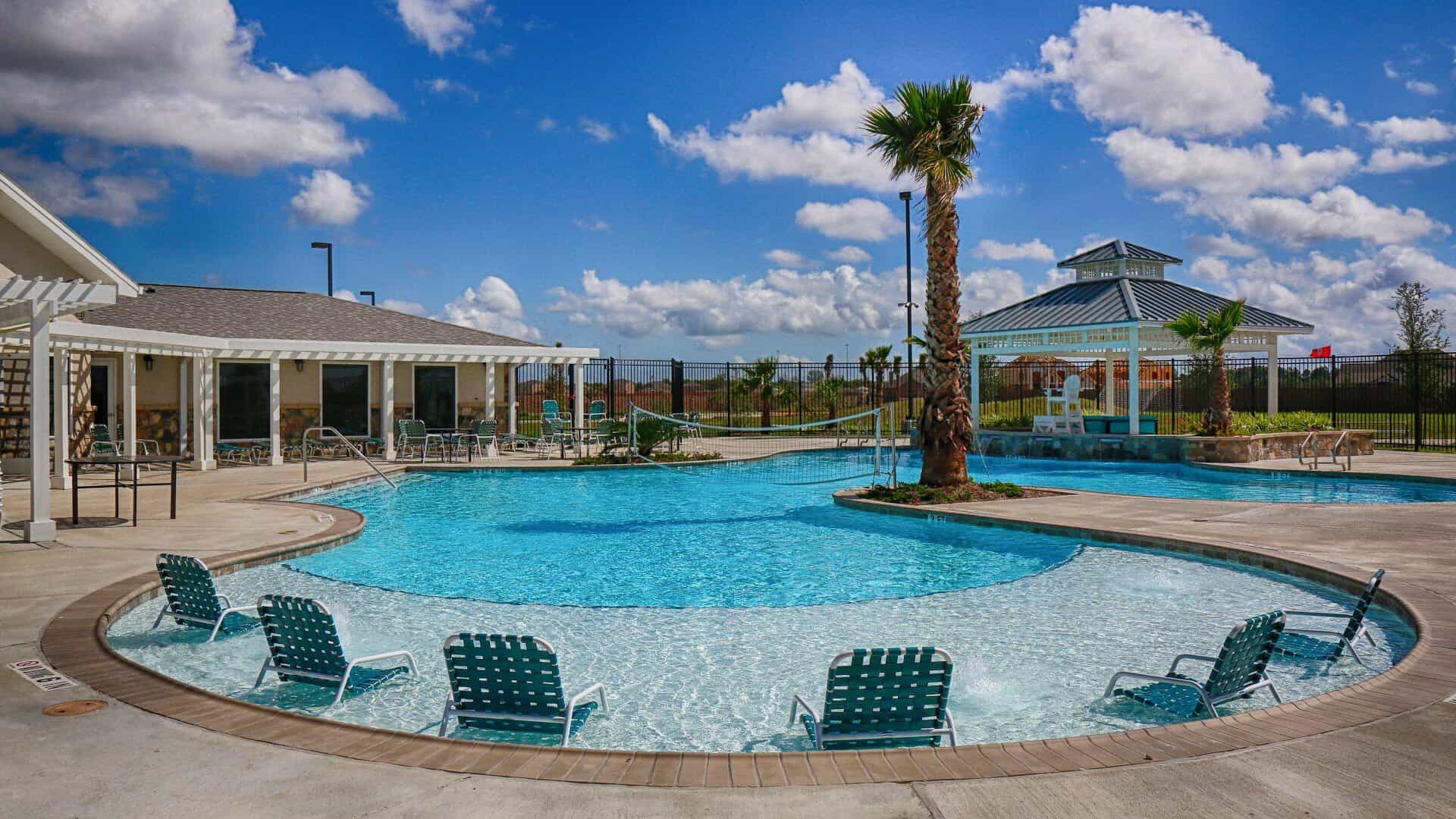 Resort-style pool with cabanas and lounge chairs at Lago Mar in Texas City