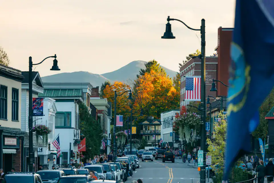 Autumn trees along Main Street with mountains in Lake Placid, New York