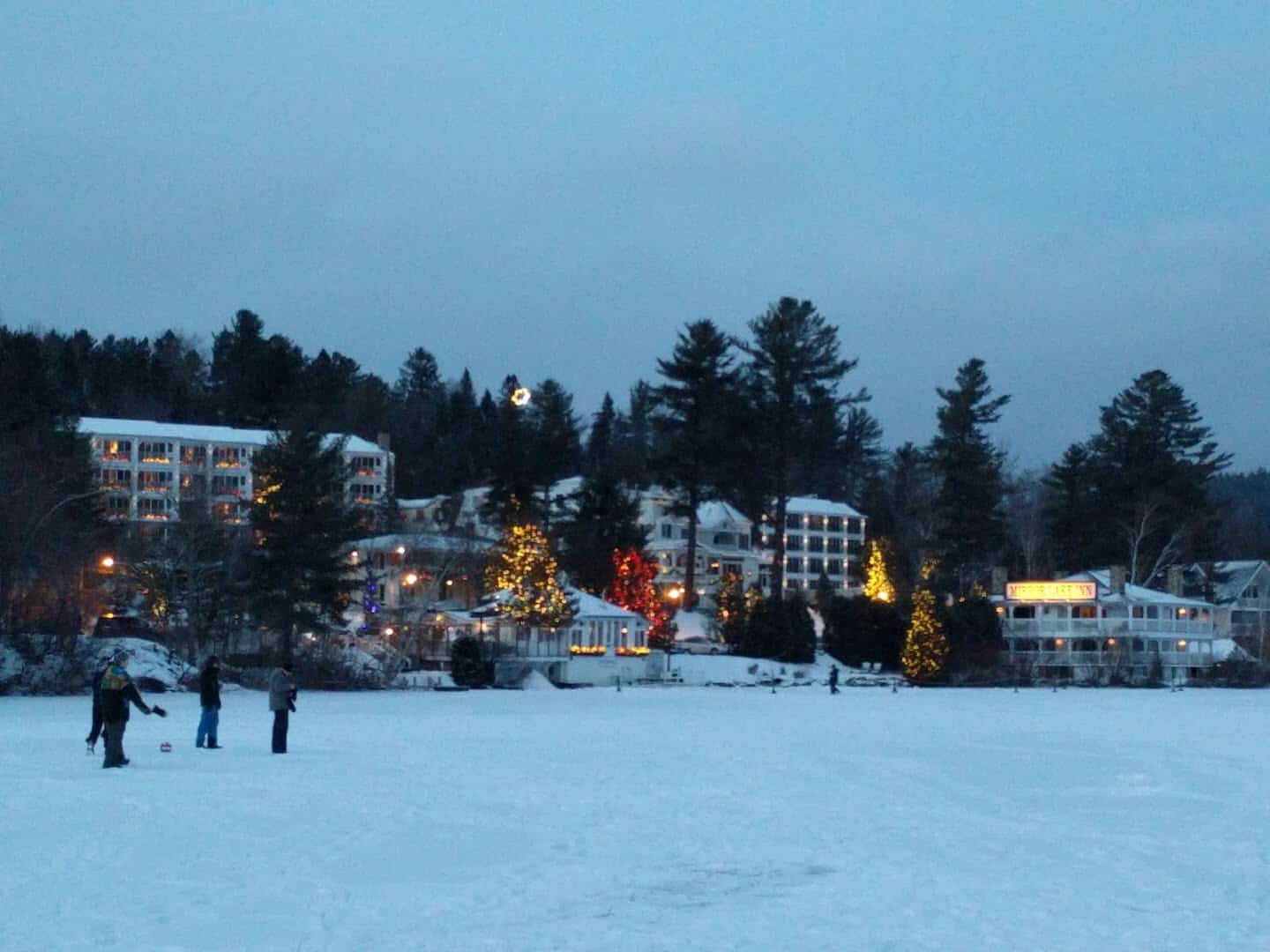 Snowy Lake Placid village beside frozen Mirror Lake, New York