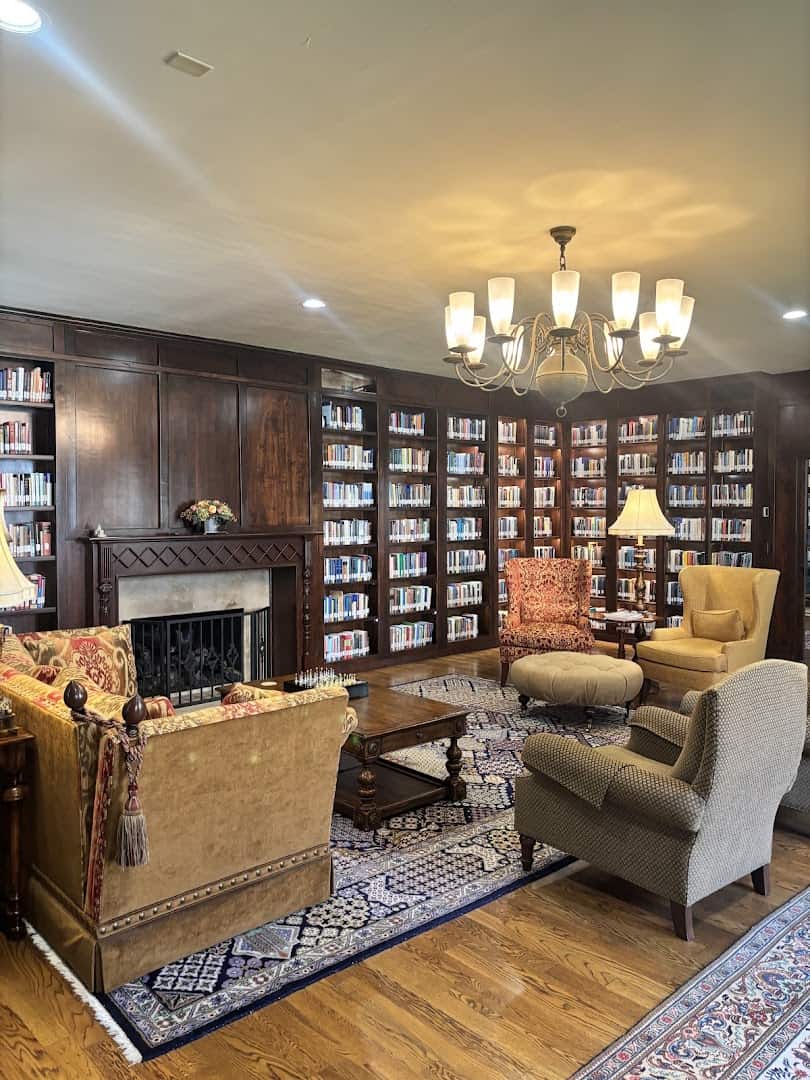 A fireplace and reading chairs in a sitting room at the Lanier Theological Library in Houston