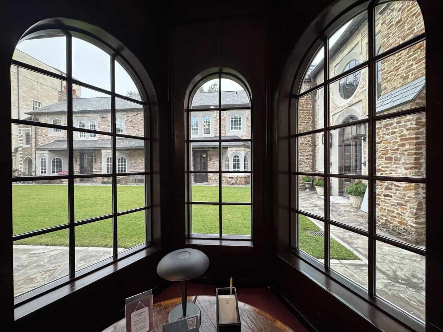 Arched windows and a reading nook overlooking the courtyard at the Lanier Theological Library