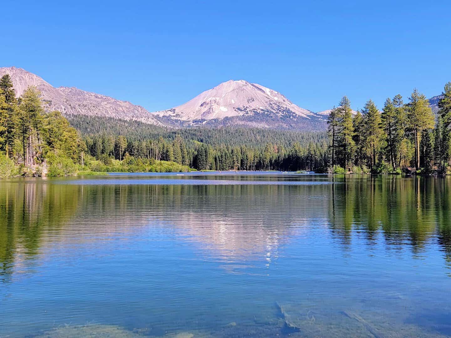 Lassen Peak reflected in an alpine lake at Lassen Volcanic National Park, California