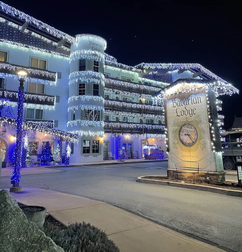The Bavarian Lodge glowing with blue and white holiday lights at night in Leavenworth, Washington