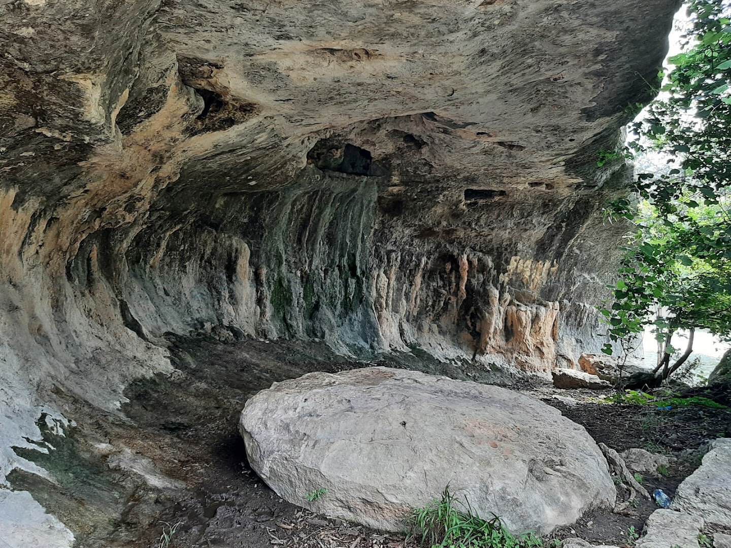 Limestone overhang and boulder along the creek bed at Tonkawa Falls City Park in Crawford, Texas