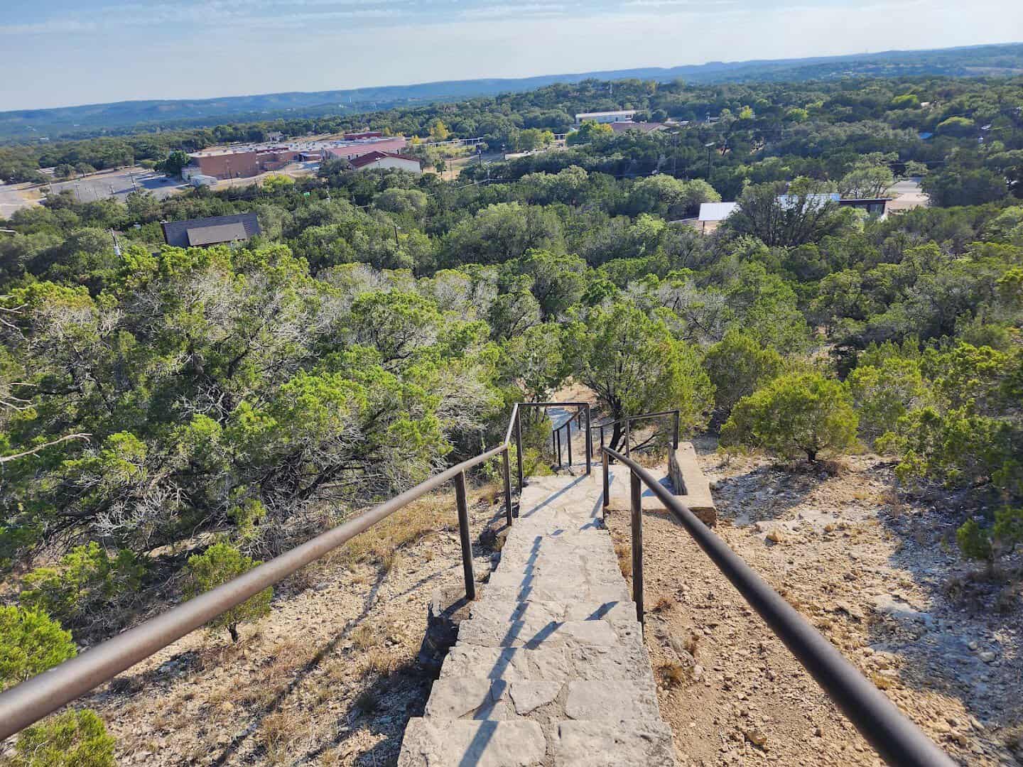 Wide limestone steps and handrails descending Old Baldy in the Hill Country