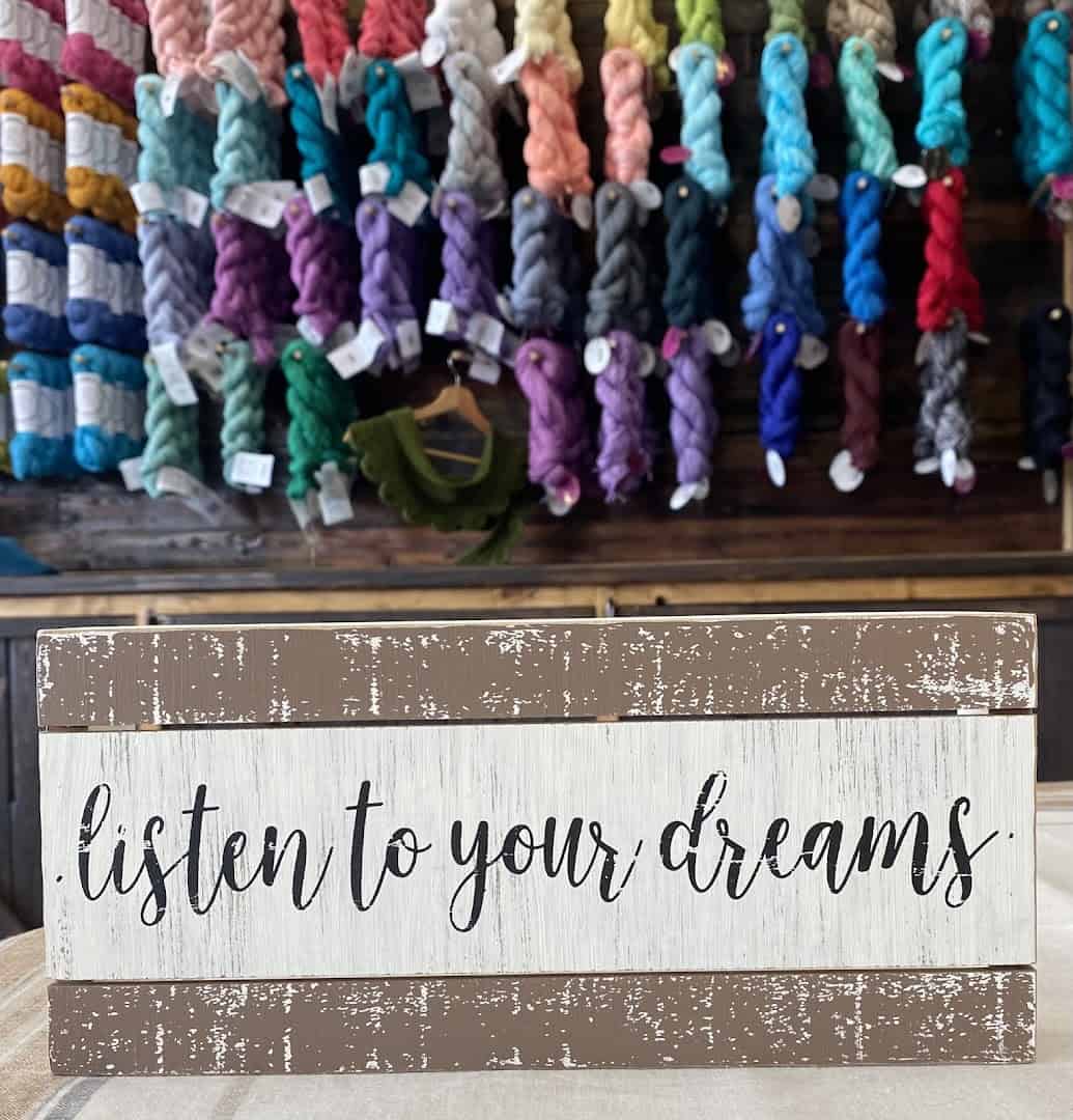 A listen to your dreams sign inside Lone Star Yarn in Bedford, Texas