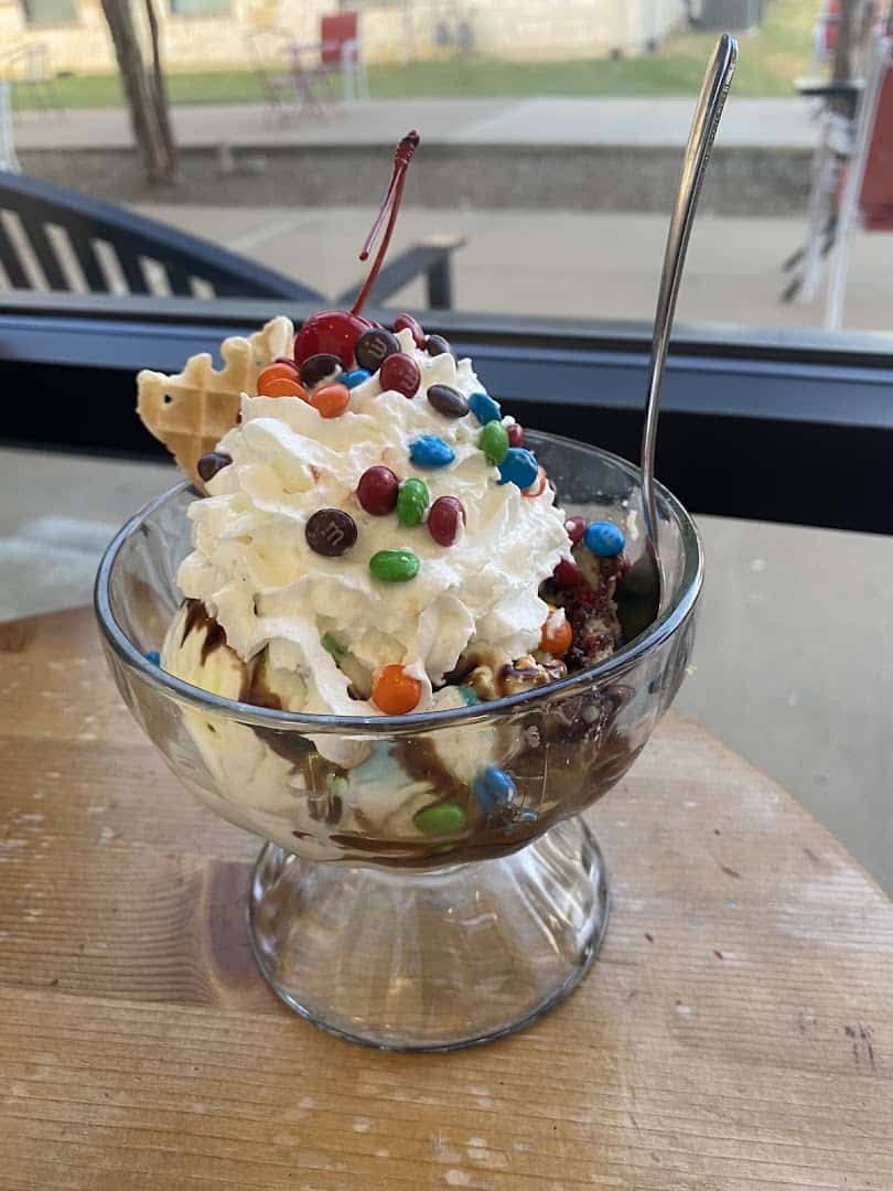 Loaded sundae with whipped cream, candy pieces and hot fudge at Beth Marie's in Denton