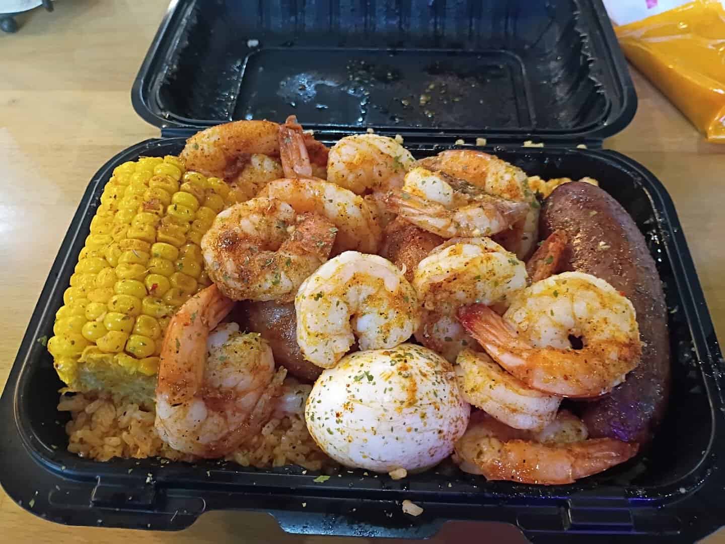 Loud Pack shrimp, corn and sausage over fried rice at Lotus Seafood in Houston