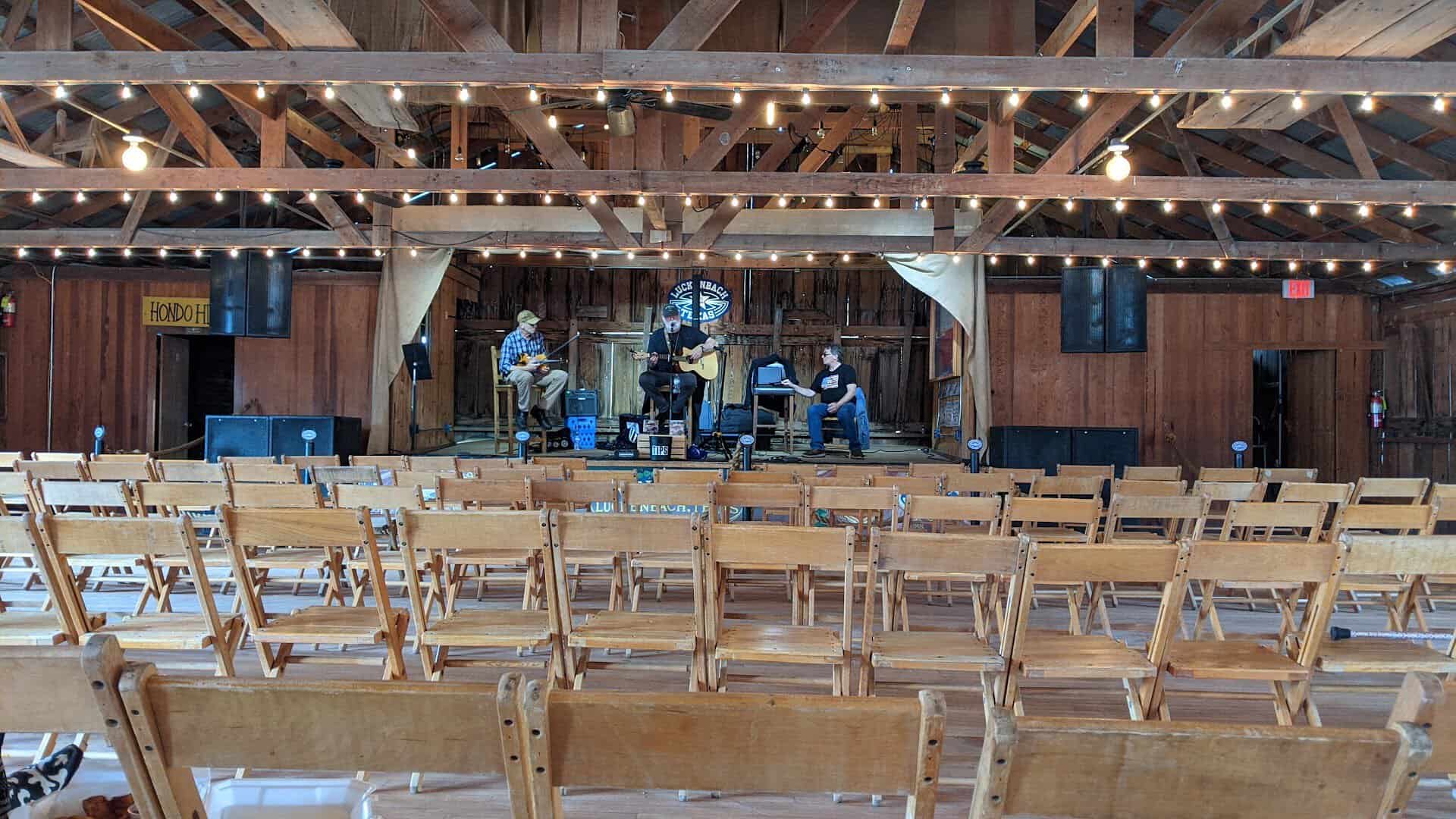 Inside the Luckenbach dance hall with its wooden chairs and string lights