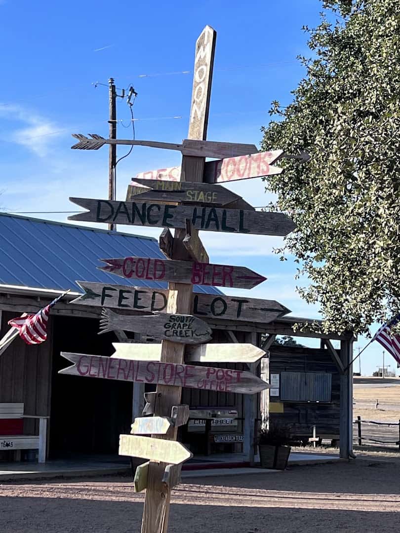 Hand painted directional sign post at Luckenbach Texas