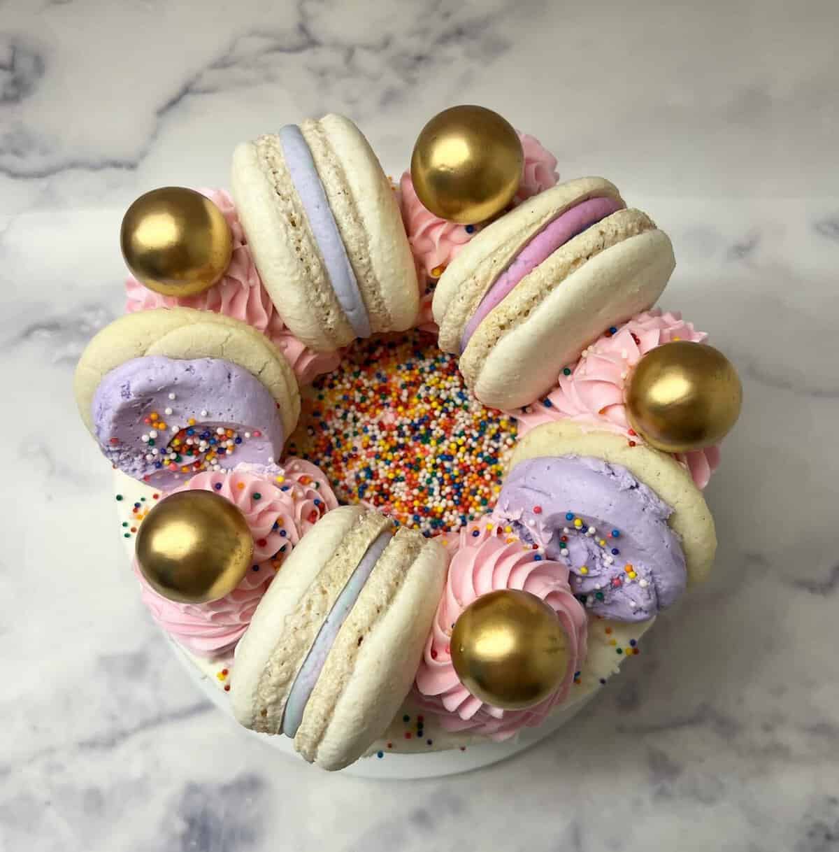 Gluten-free cake topped with macarons and sprinkles at Sweet Gilly's