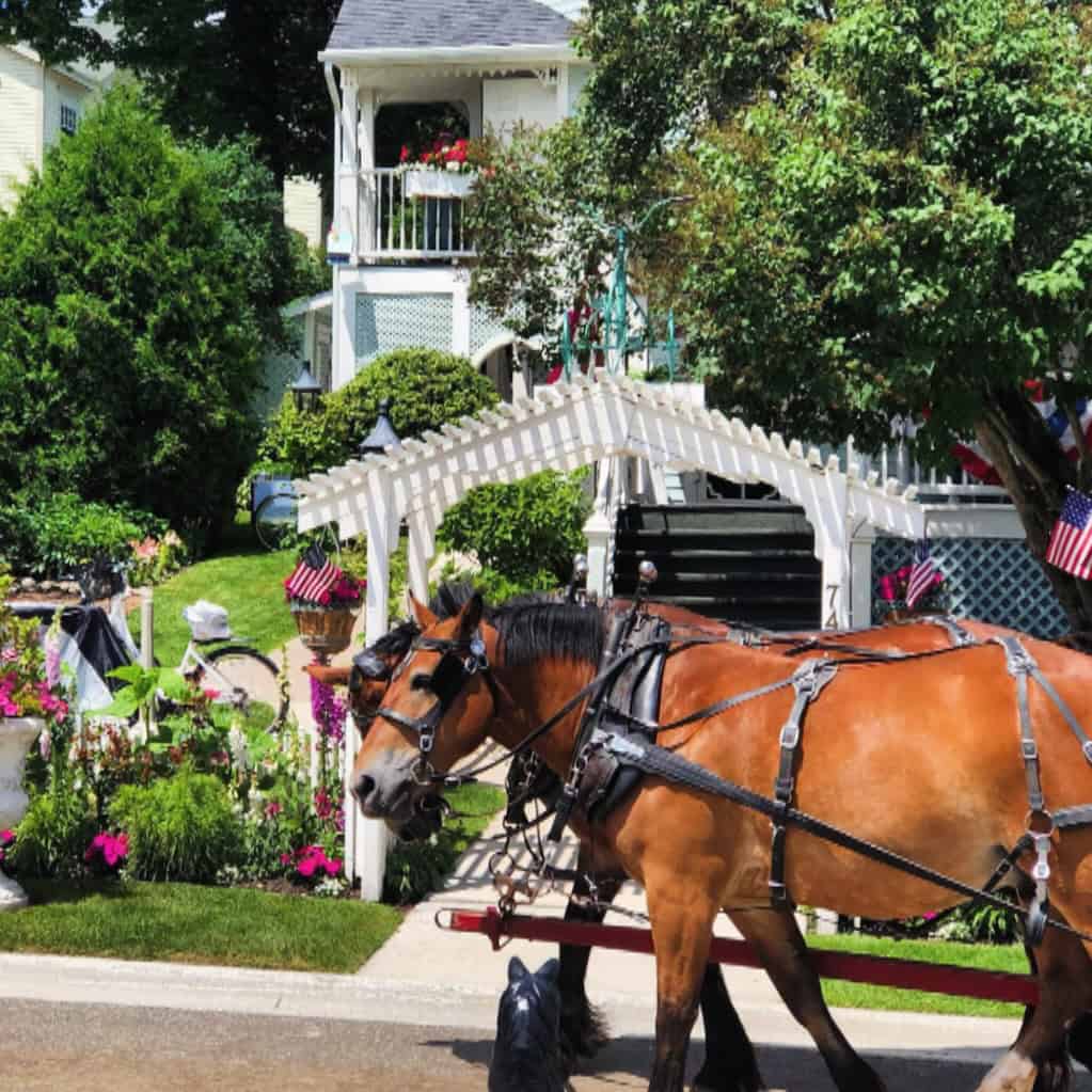 A horse-drawn carriage on a Victorian street on Mackinac Island, Michigan
