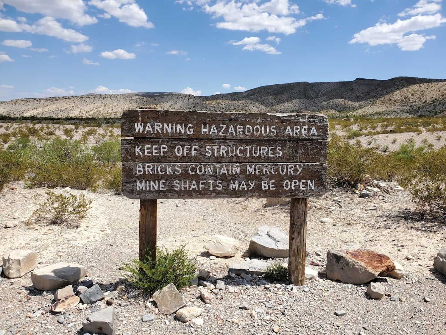 Warning sign at Mariscal Mine asking hikers to keep off structures because bricks contain mercury