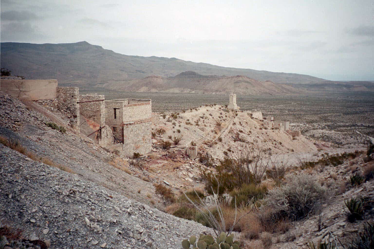 Mariscal Mine ruins with desert and mountains stretching behind them