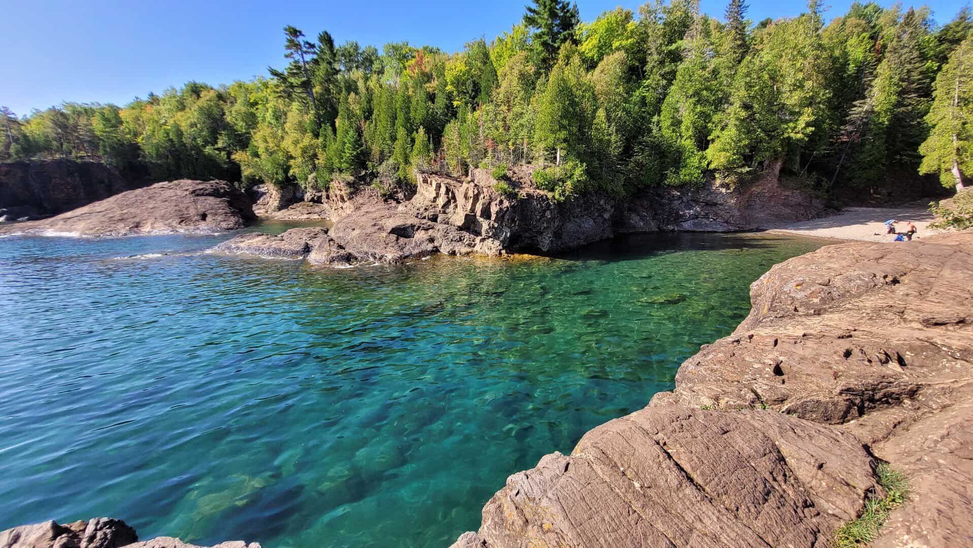 Turquoise water and red rocks along Lake Superior at Presque Isle Park in Marquette, Michigan