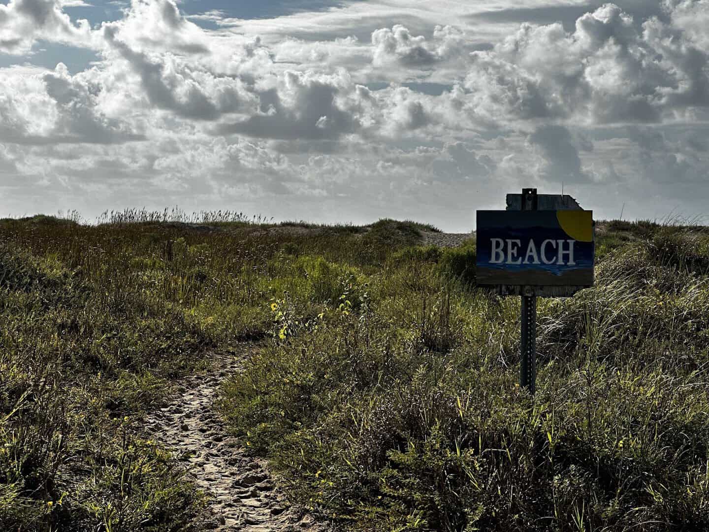 Weathered beach sign in the dunes at Matagorda Beach, Texas