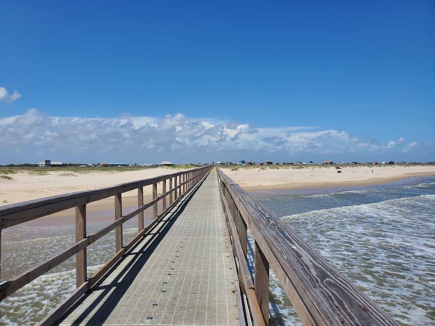 Fishing pier over the sand at Matagorda Beach near the mouth of the Colorado River, Texas
