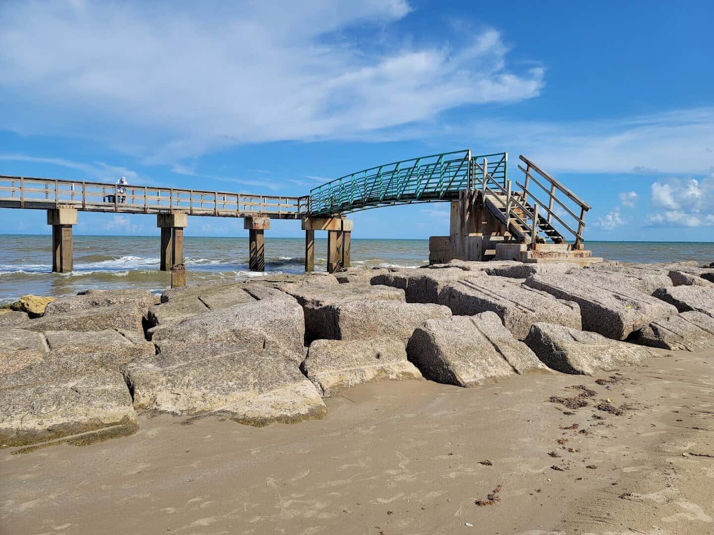 Fishing pier and rock jetty at Matagorda Beach, Texas