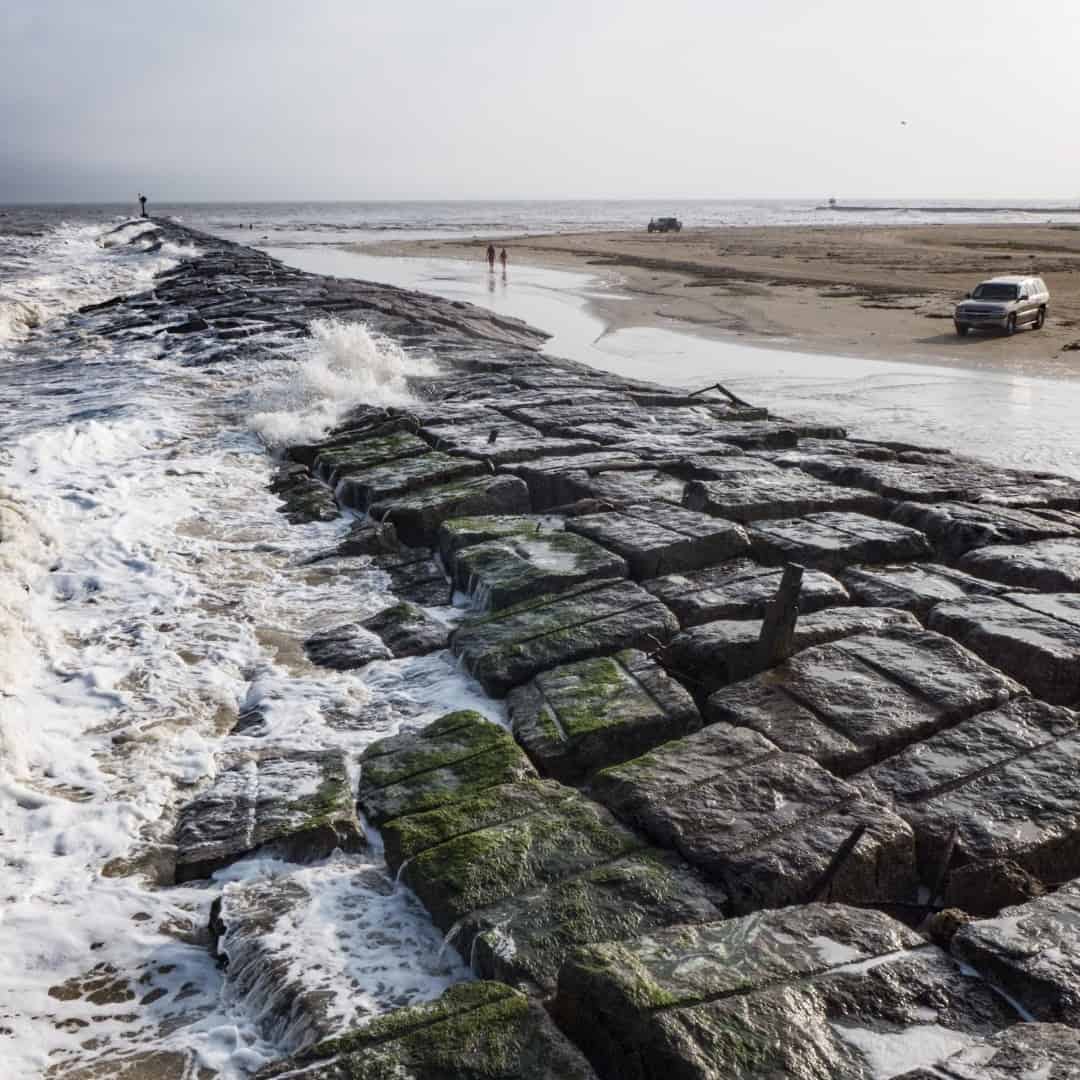 Rock jetty and Gulf surf at the mouth of the Colorado River, Matagorda Beach, Texas