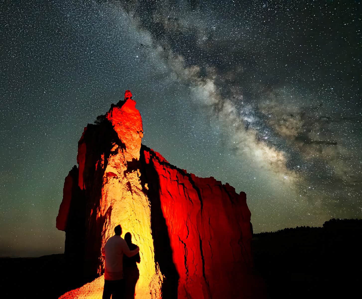 The Milky Way over a lit hoodoo spire at Bryce Canyon National Park, Utah