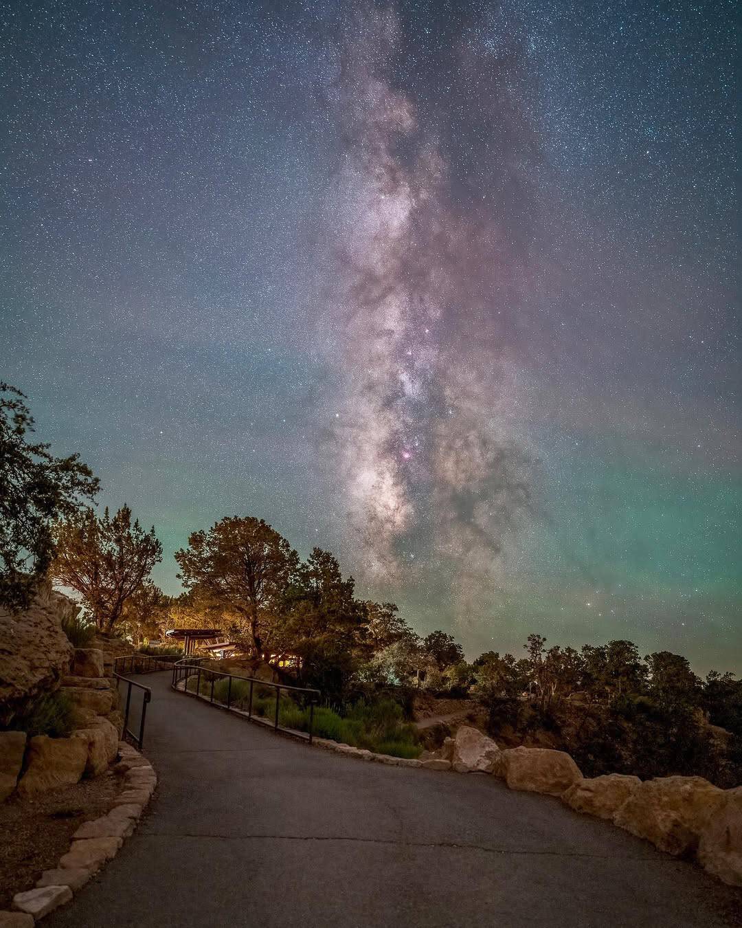 The Milky Way arching over a rim overlook at Grand Canyon National Park, Arizona