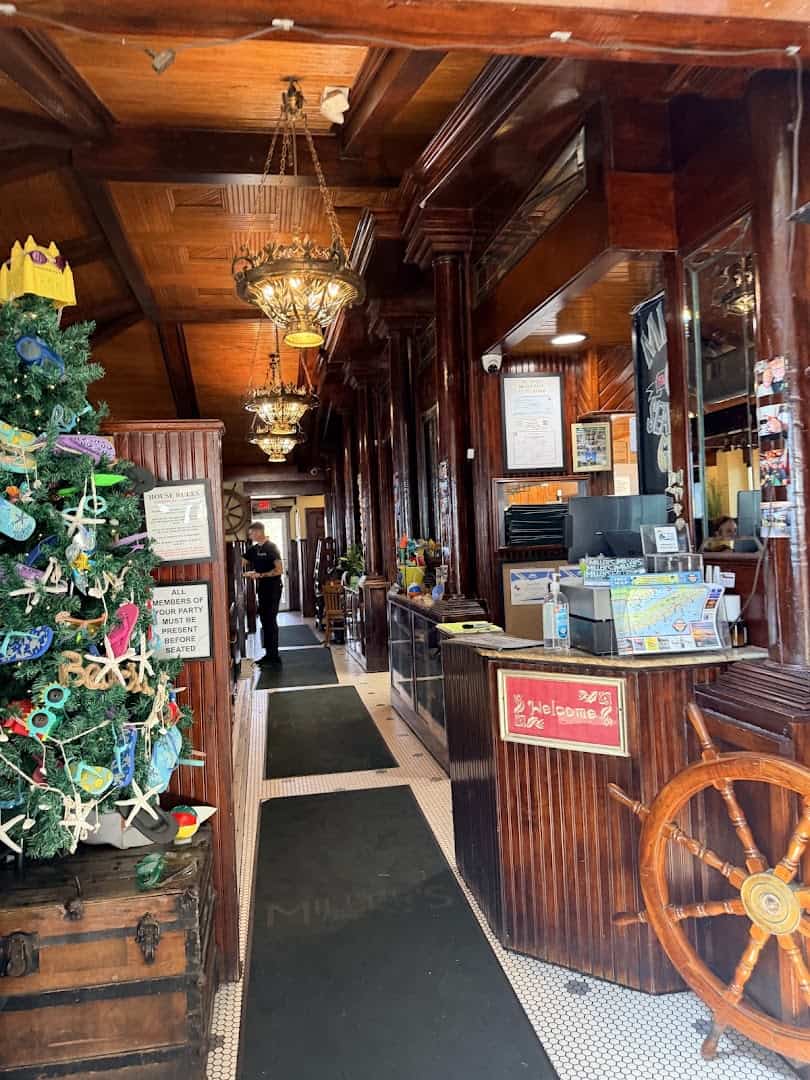 Warm wood interior and host stand at Miller's Seawall Grill in Galveston, Texas