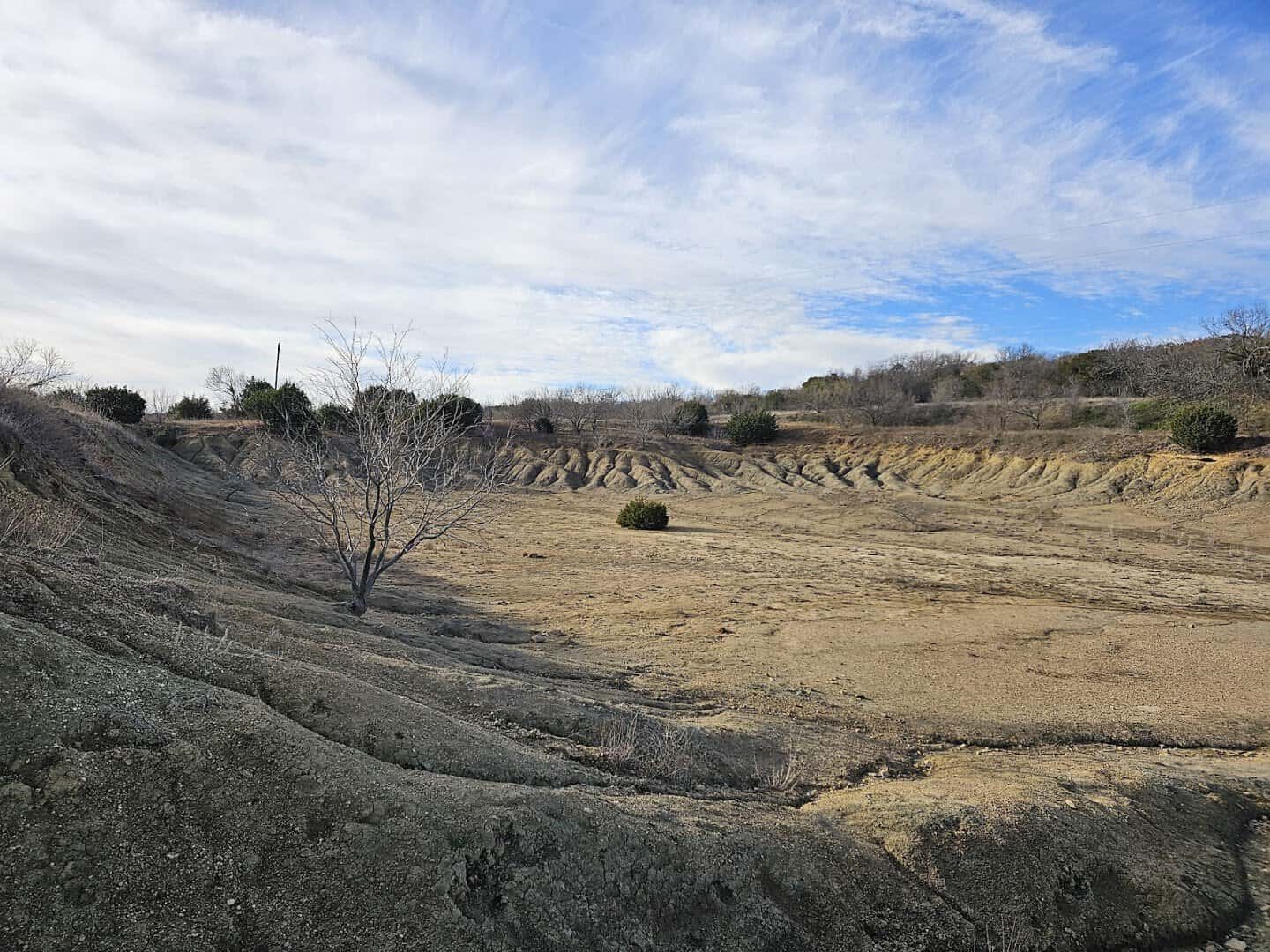 The eroded gray hillside of Mineral Wells Fossil Park in Texas where visitors dig for fossils