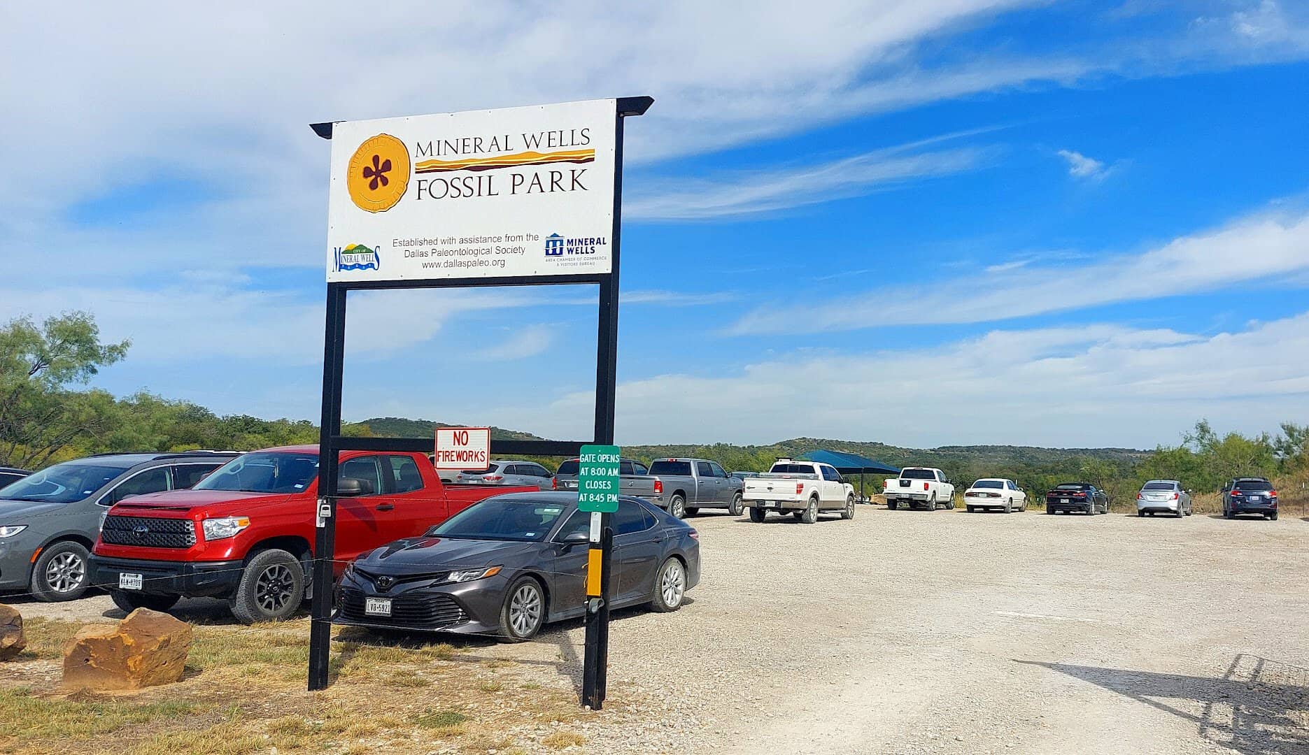 The entrance sign and parking lot at Mineral Wells Fossil Park in Mineral Wells, Texas