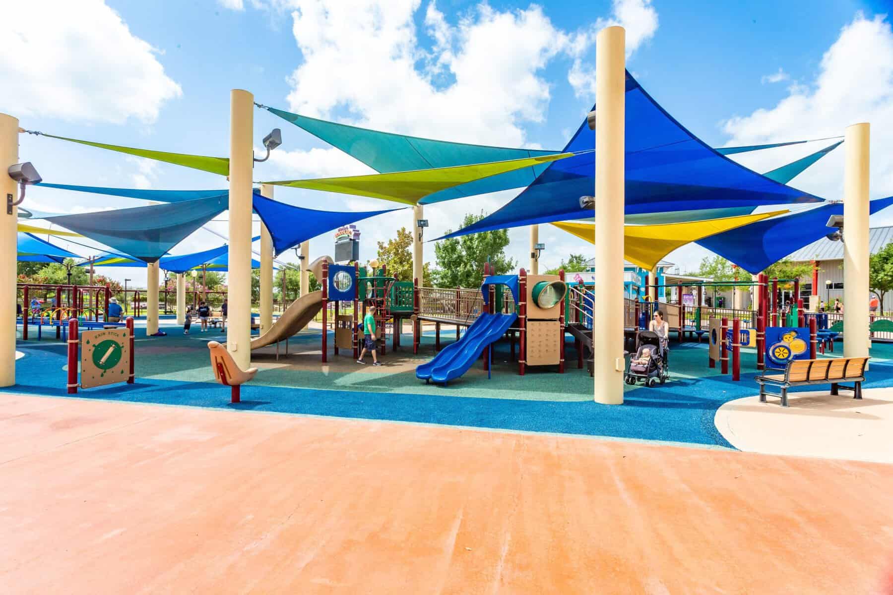 Colorful fully accessible playground with ramps and shade sails at Morgan's Wonderland in San Antonio