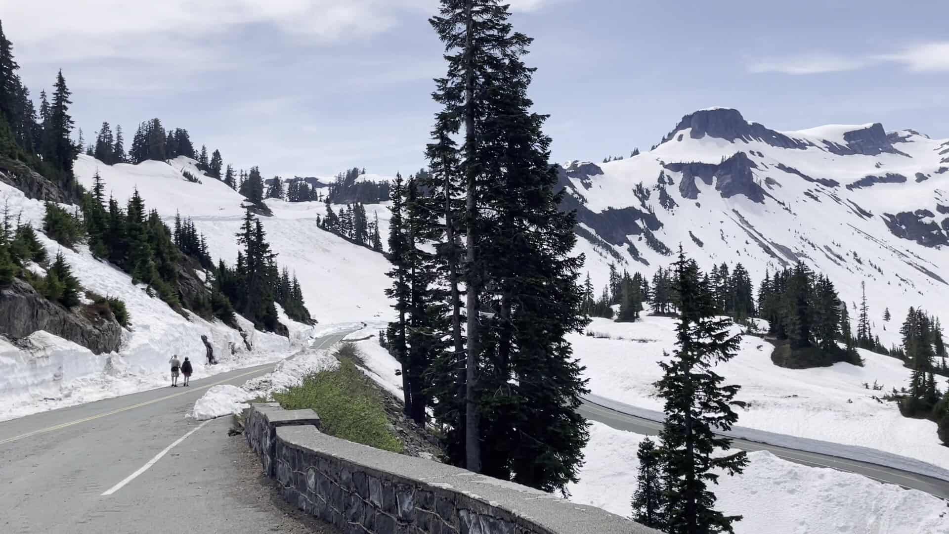The snow-lined road climbing toward Artist Point beneath the peaks of the Mount Baker area, Washington