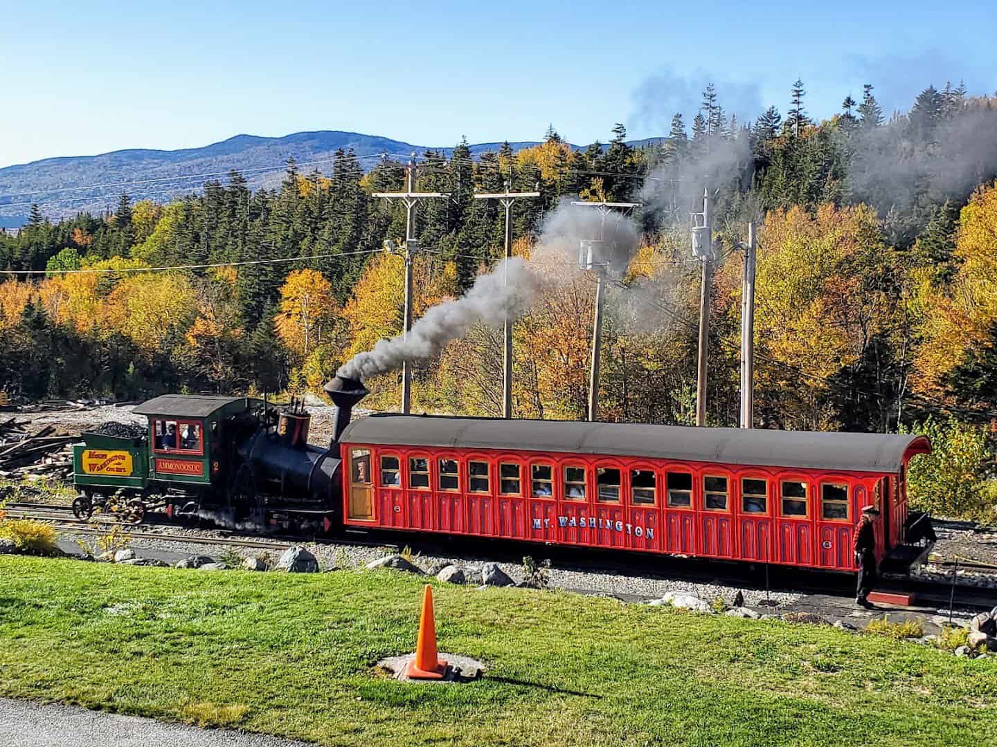 Mount Washington Cog Railway train climbing the mountain amid autumn foliage, New Hampshire