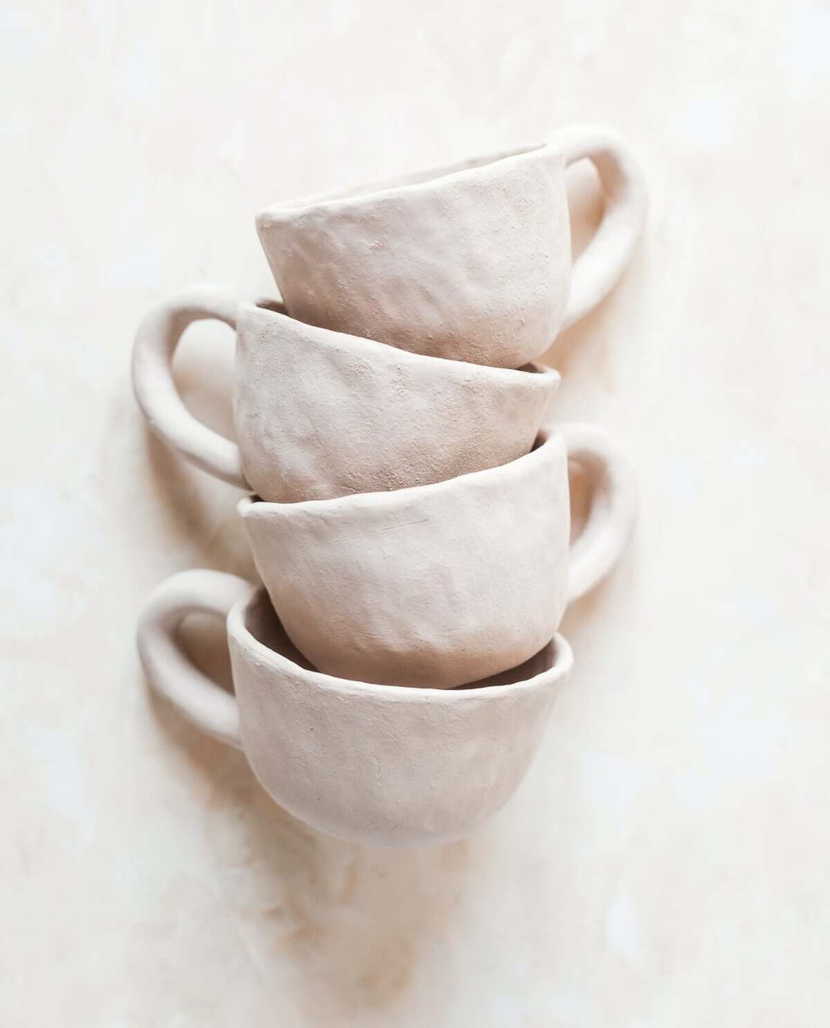 Stack of handmade clay cups from Muddy Pants Pottery in downtown Nacogdoches